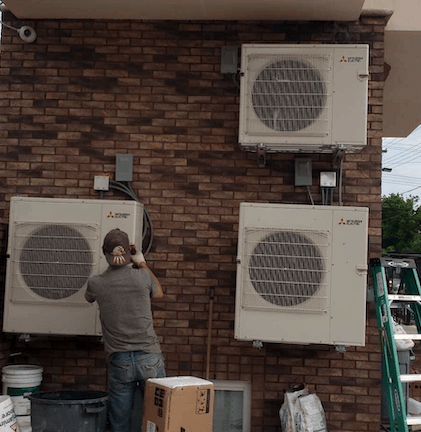 Blue Peak HVAC Inc installation – exterior unit on brick wall
